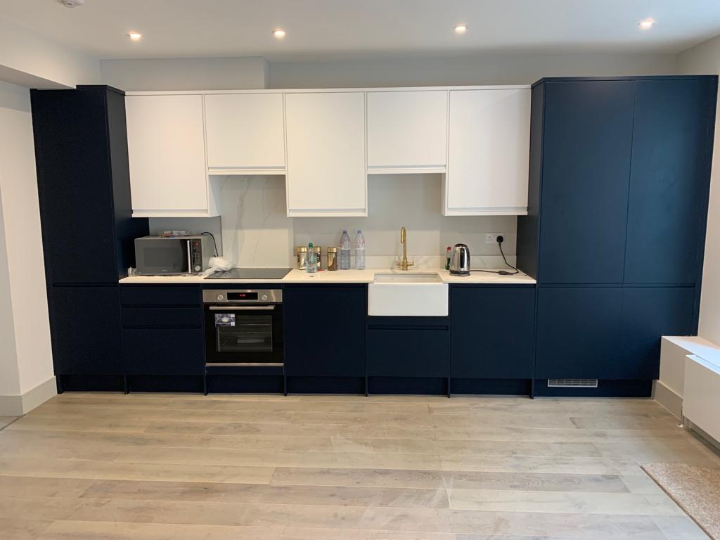 Kitchen navy white units Belfast sink gold tap